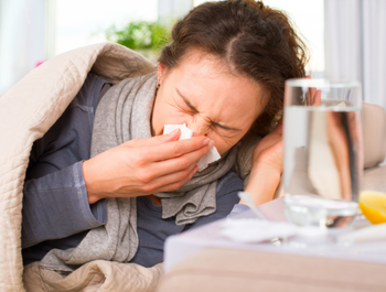 Sick Woman. Flu. Woman Caught Cold. Sneezing into Tissue 