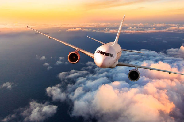 A commercial jet flying above the clouds